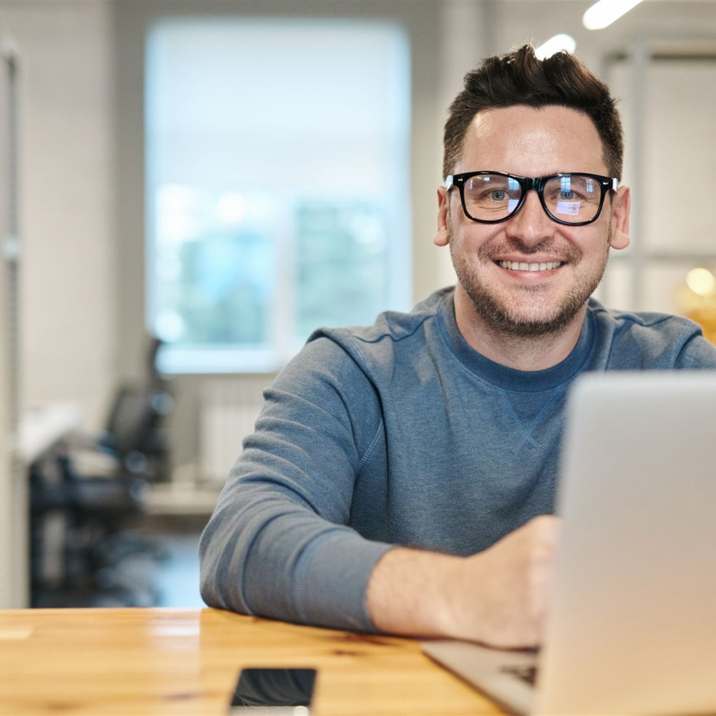 Trader with laptop working in office